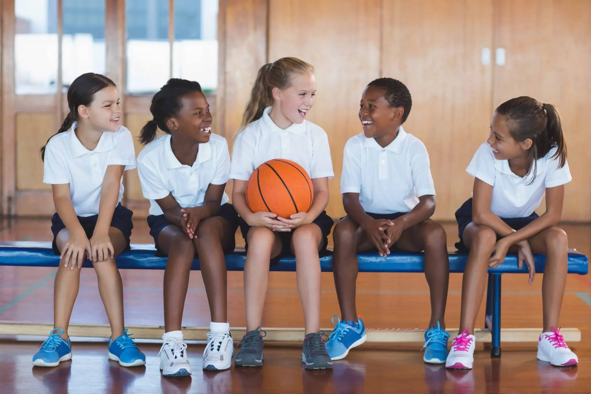 School kids having fun in basketball court