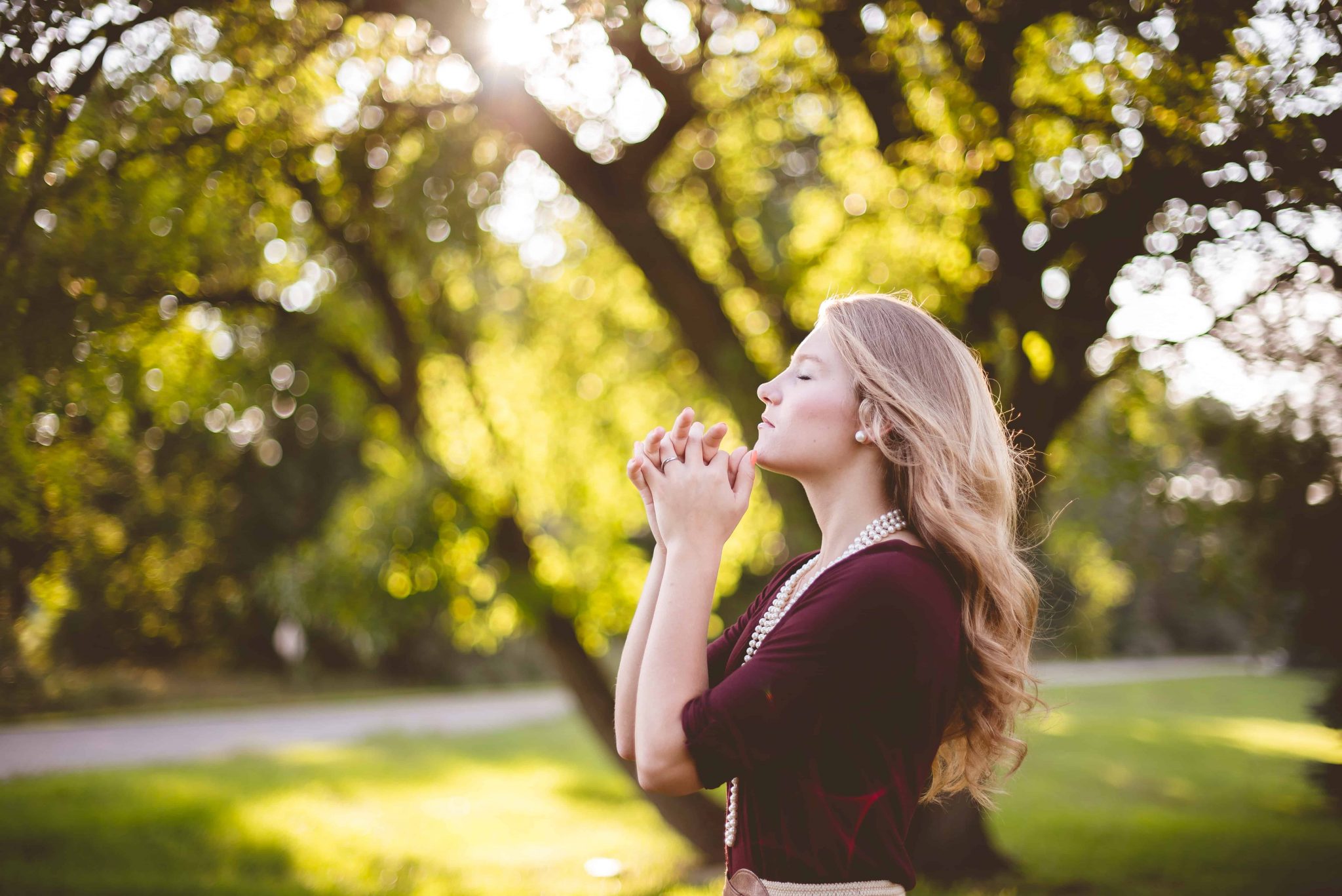 woman praying prayer outside