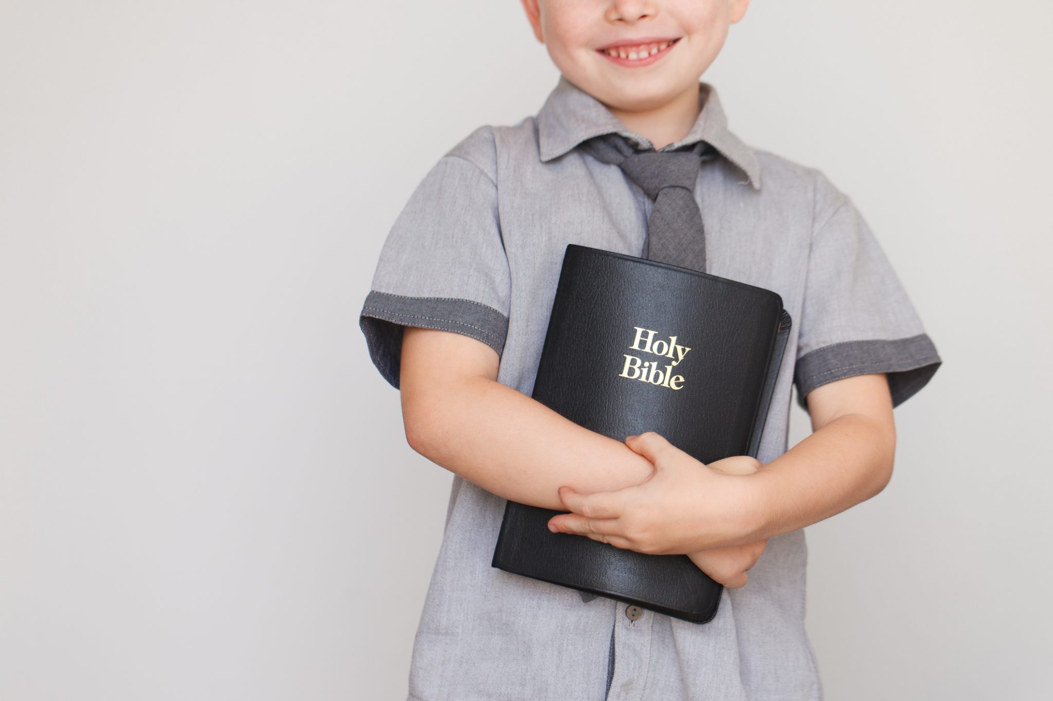 Boy holding Holy Bible book
